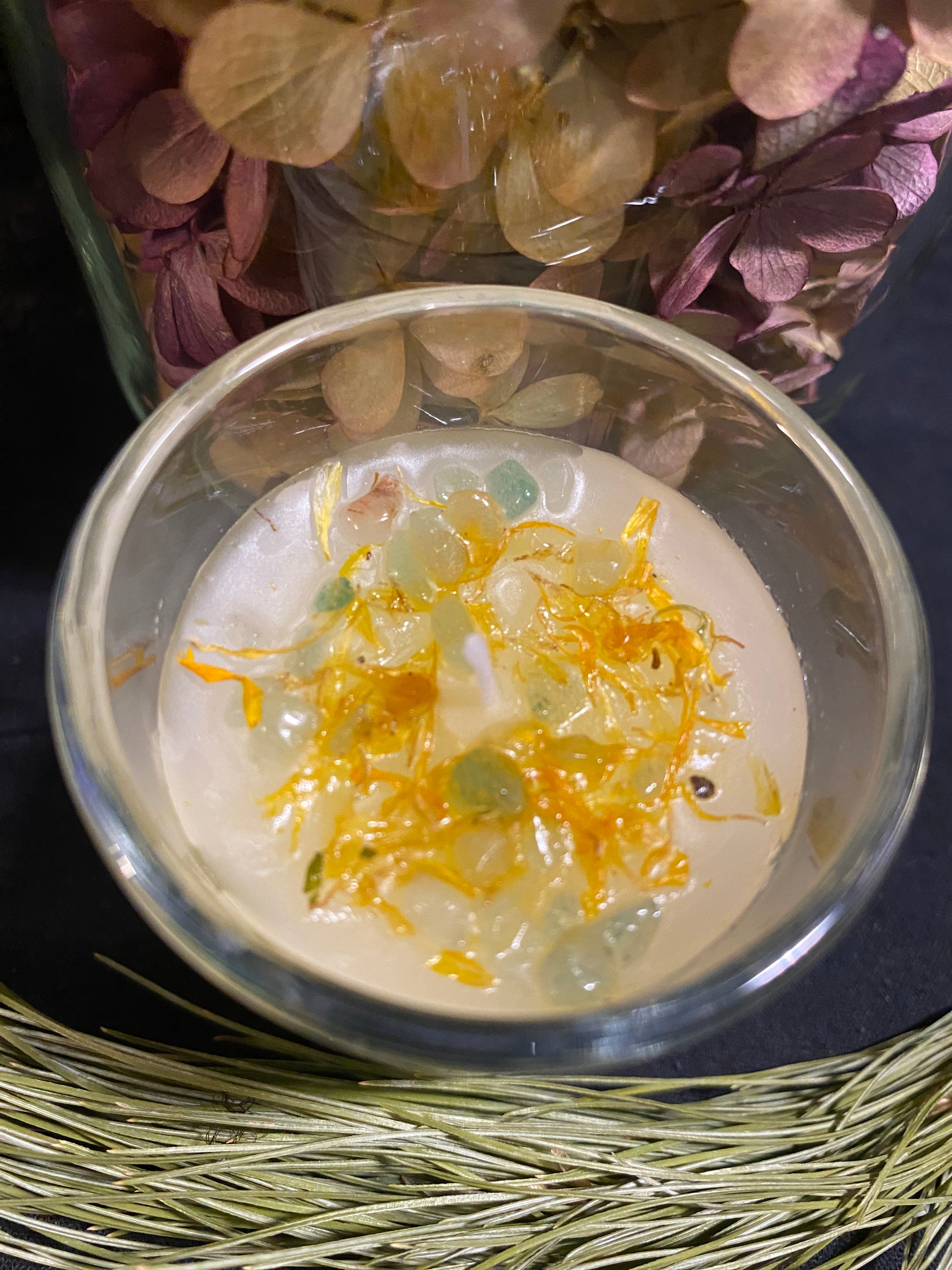 Prosperity and Abundance candle. Adorned with the powerful citrine and aventurine stones. Dressed with herbs and flowers. 